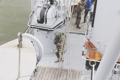 High angle view of army soldiers standing on nautical vessel