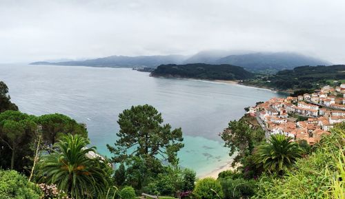 High angle view of sea and mountains against sky