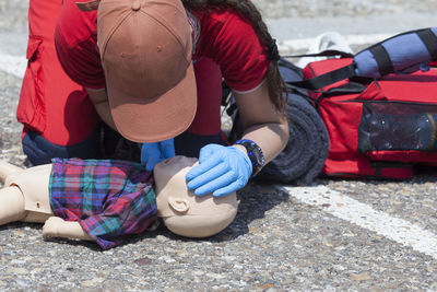 Woman demonstrating emergency rescue for baby toy