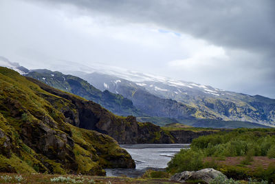 Scenic view of mountains against cloudy sky