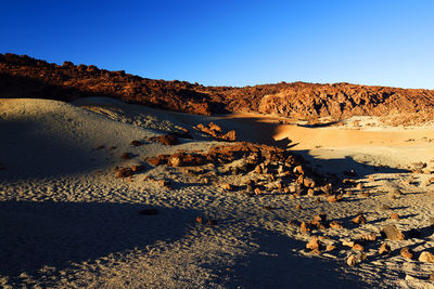 Scenic view of landscape at el teide national park against clear blue sky