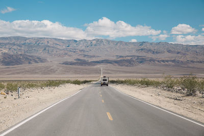 Road in desert against sky