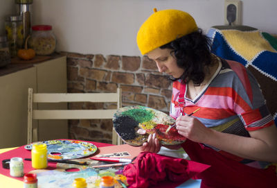 Woman holding umbrella on table at home