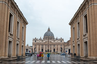 View of basilica of saint peter  with people on the crosswalks