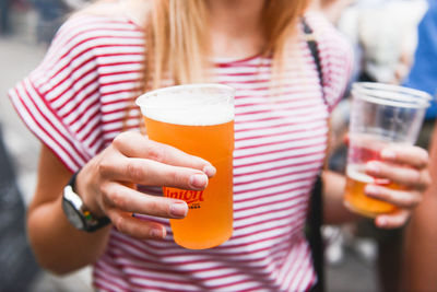 Midsection of man drinking glass