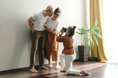 Rear view of woman standing on floor