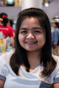 Close-up portrait of smiling young woman