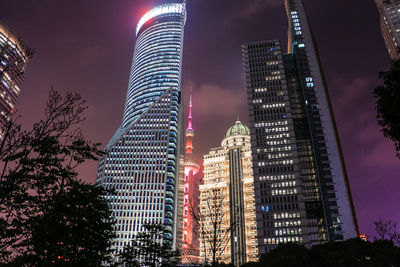 Low angle view of skyscrapers lit up at night