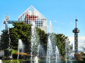 Low angle view of modern buildings against blue sky