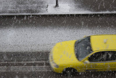 High angle view of yellow taxi on road during winter