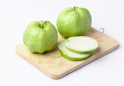 High angle view of green fruits on cutting board