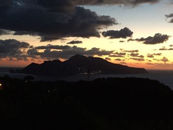 Scenic view of silhouette mountains against sky at sunset