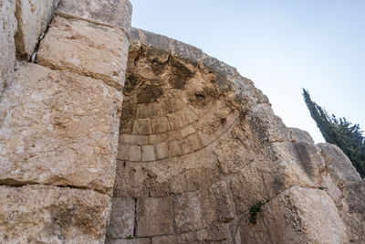 Low angle view of rock formation against sky