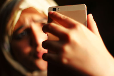 Close-up portrait of man using mobile phone