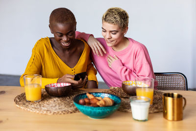 Portrait of happy family having food at home