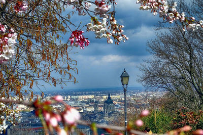 View of cityscape against cloudy sky