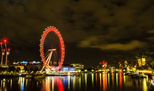 Illuminated ferris wheel at night