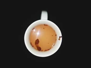 Directly above shot of coffee cup against black background