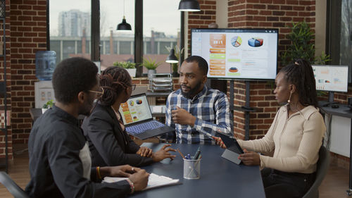 Businessman with colleagues discussing work at office