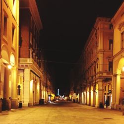 Empty walkway in city at night