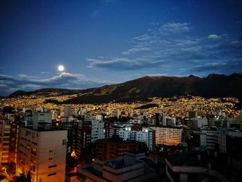 Aerial view of townscape against sky at night