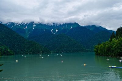 Scenic view of lake against cloudy sky