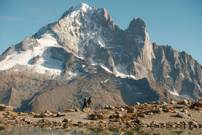 Friends walking against mountain