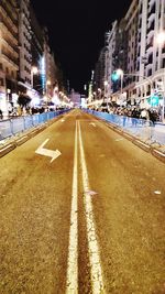 Surface level of road along buildings at night