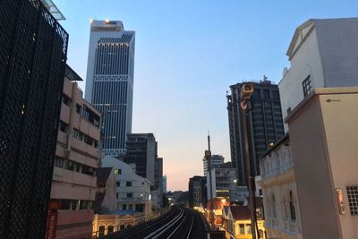 Low angle view of buildings against clear sky in city