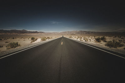 Country road against sky