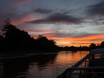 Scenic view of lake against orange sky