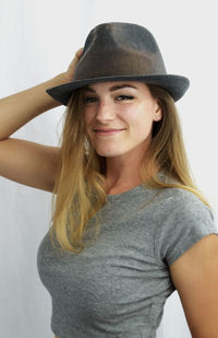 Portrait of smiling young woman against white background