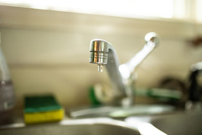 Close-up of faucet on table at home