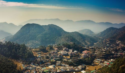 High angle view of townscape and mountains against sky