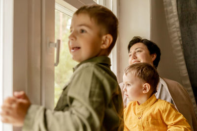 Boy looking through window