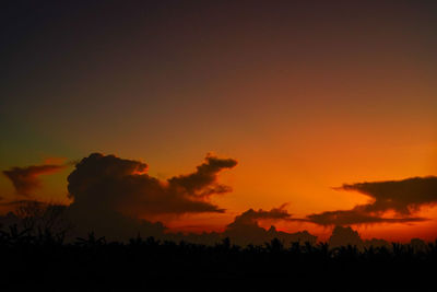 Scenic view of silhouette trees against romantic sky at sunset