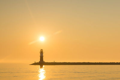 Scenic view of sea against orange sky