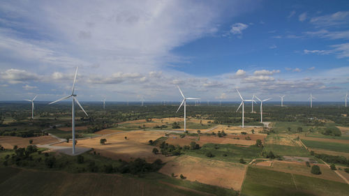 Windmill on field against sky