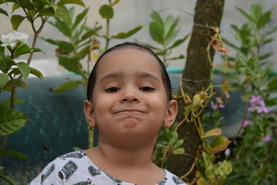 Portrait of cute boy against plants