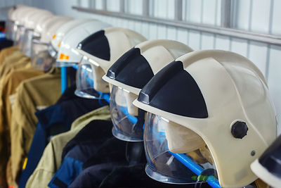 Close-up of crash helmet with jacket hanging at store