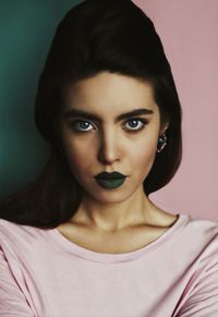 Portrait of beautiful young woman with green lipstick