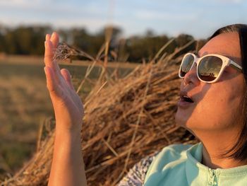 Portrait of woman wearing sunglasses on land