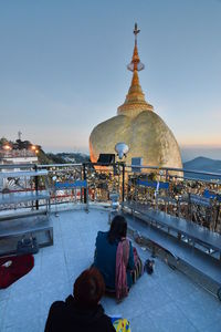 People at temple against clear sky