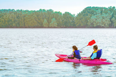 People in boat on lake