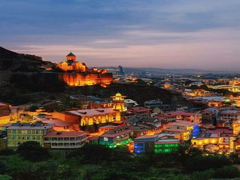 High angle view of illuminated buildings against sky at sunset