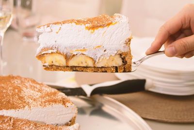 Close-up of hand holding cake