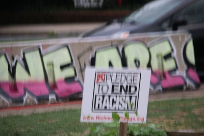 Close-up of information sign on grass