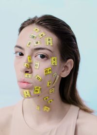 Portrait of young woman against white background