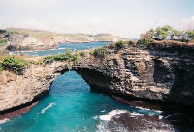 High angle view of rock formation amidst sea against sky