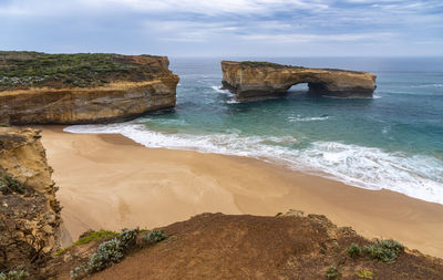 Scenic view of rocks in sea against sky